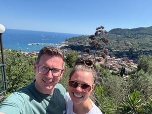 Jenny and Greger above a coastline with a harbour below