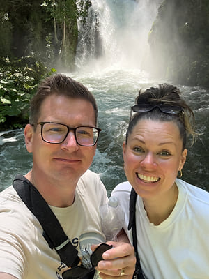 Jenny and Greger standing in front of a waterfall
